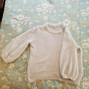 Fluffy cream-colored oversized distressed sweater